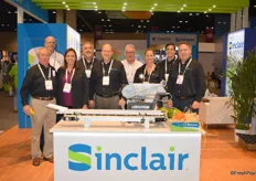 Sinclair just launched a new logo. The team of Sinclair in the new booth with the V6 High Speed Labeling machine in front.